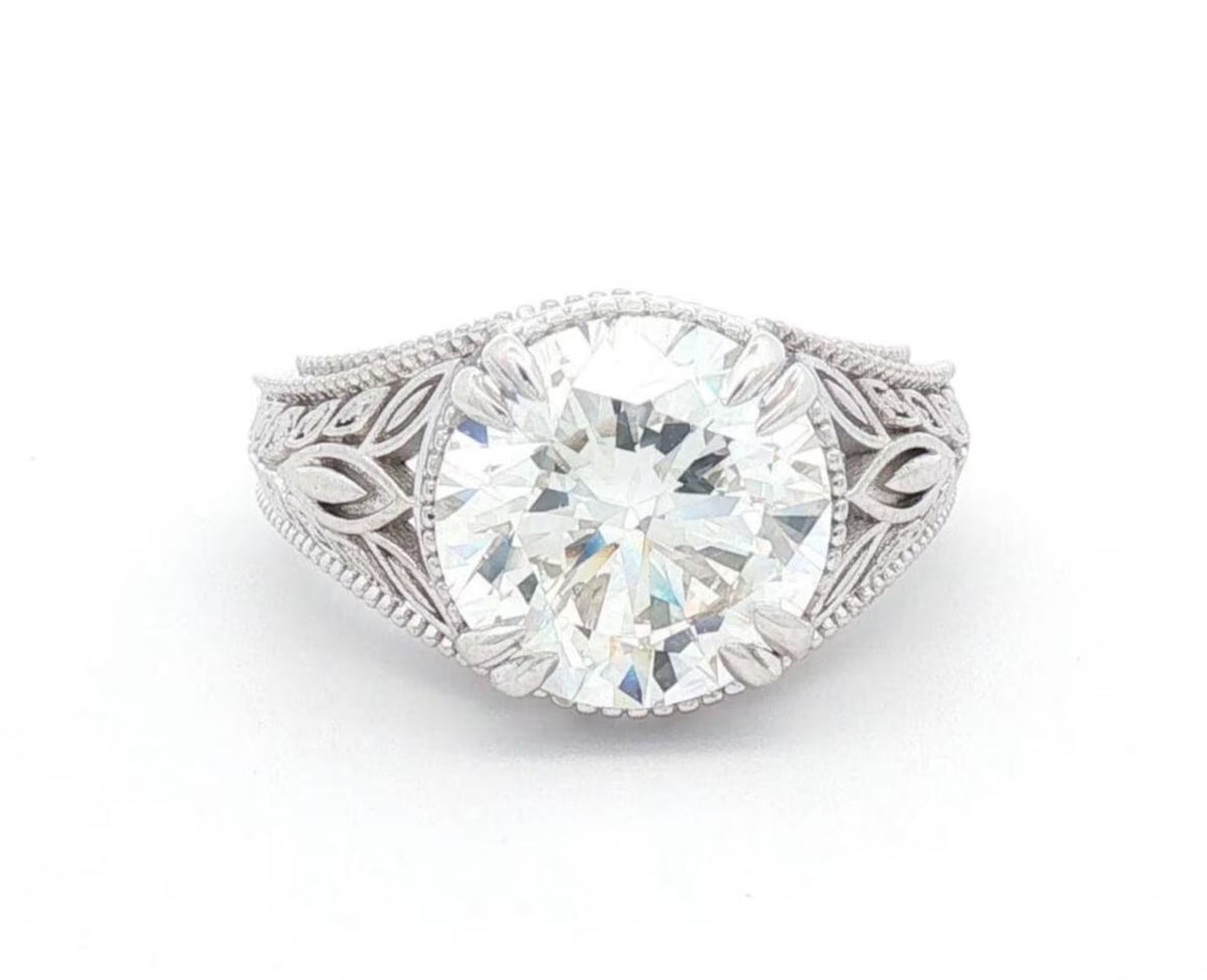 Top-down view displaying a brilliant 4 CT round lab grown diamond surrounded by leaf shoulders.