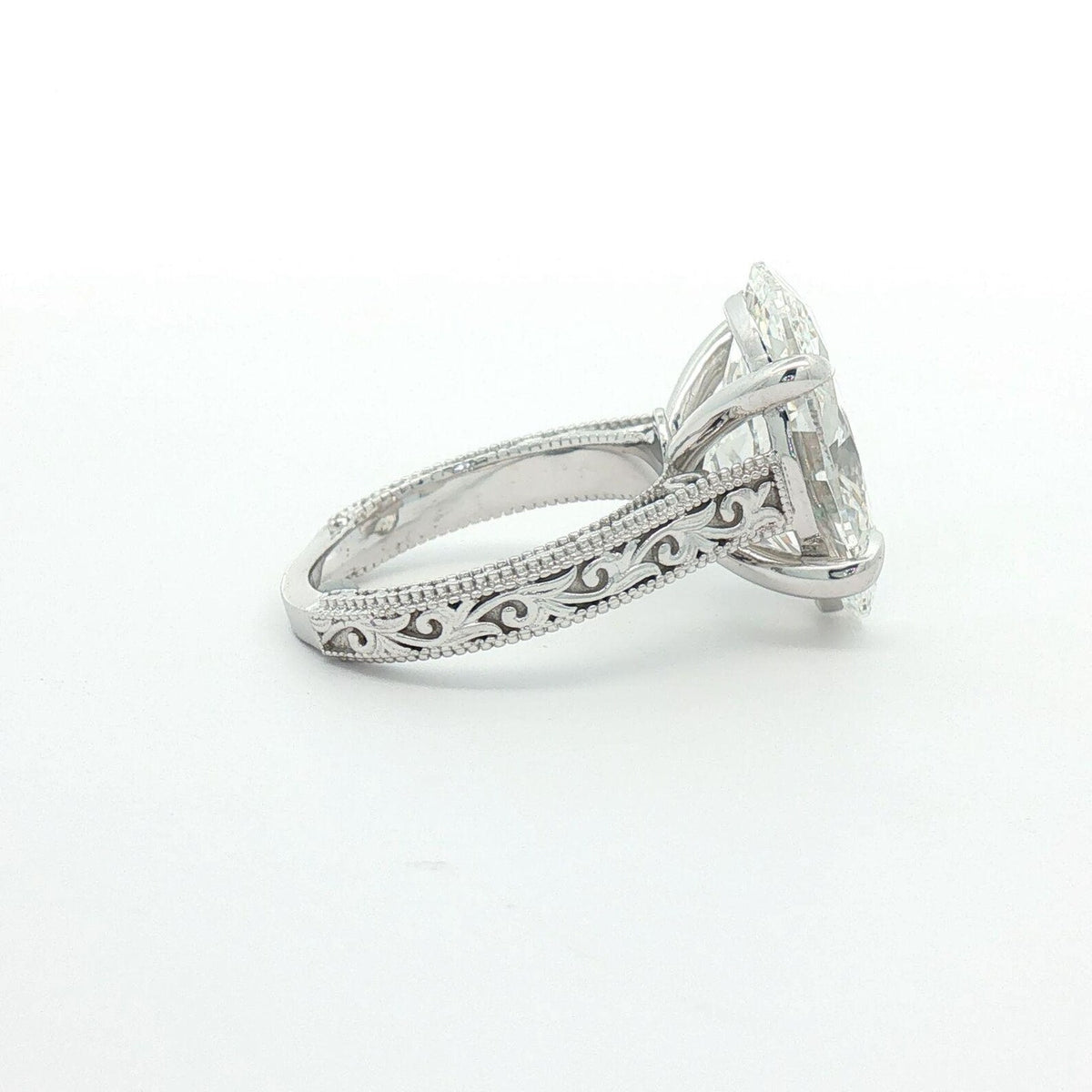 Side profile of 4 carat oval lab grown diamond engagement ring showing detailed scrollwork
