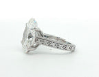 Close-up side view of vintage floral filigree carving on 4 carat oval ring band