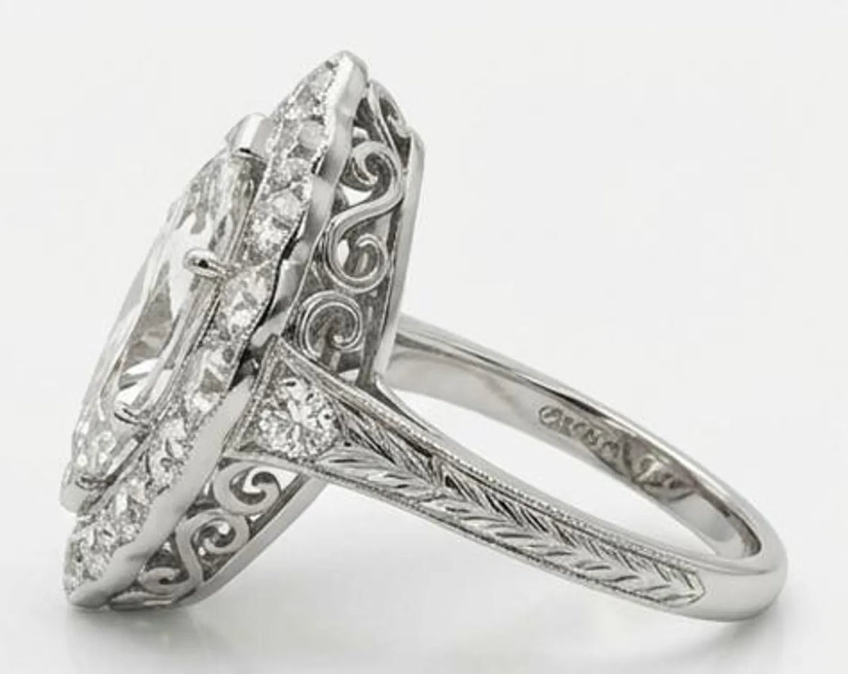 Side profile of 3 carat marquise lab grown diamond ring with filigree under gallery and hand engraved band