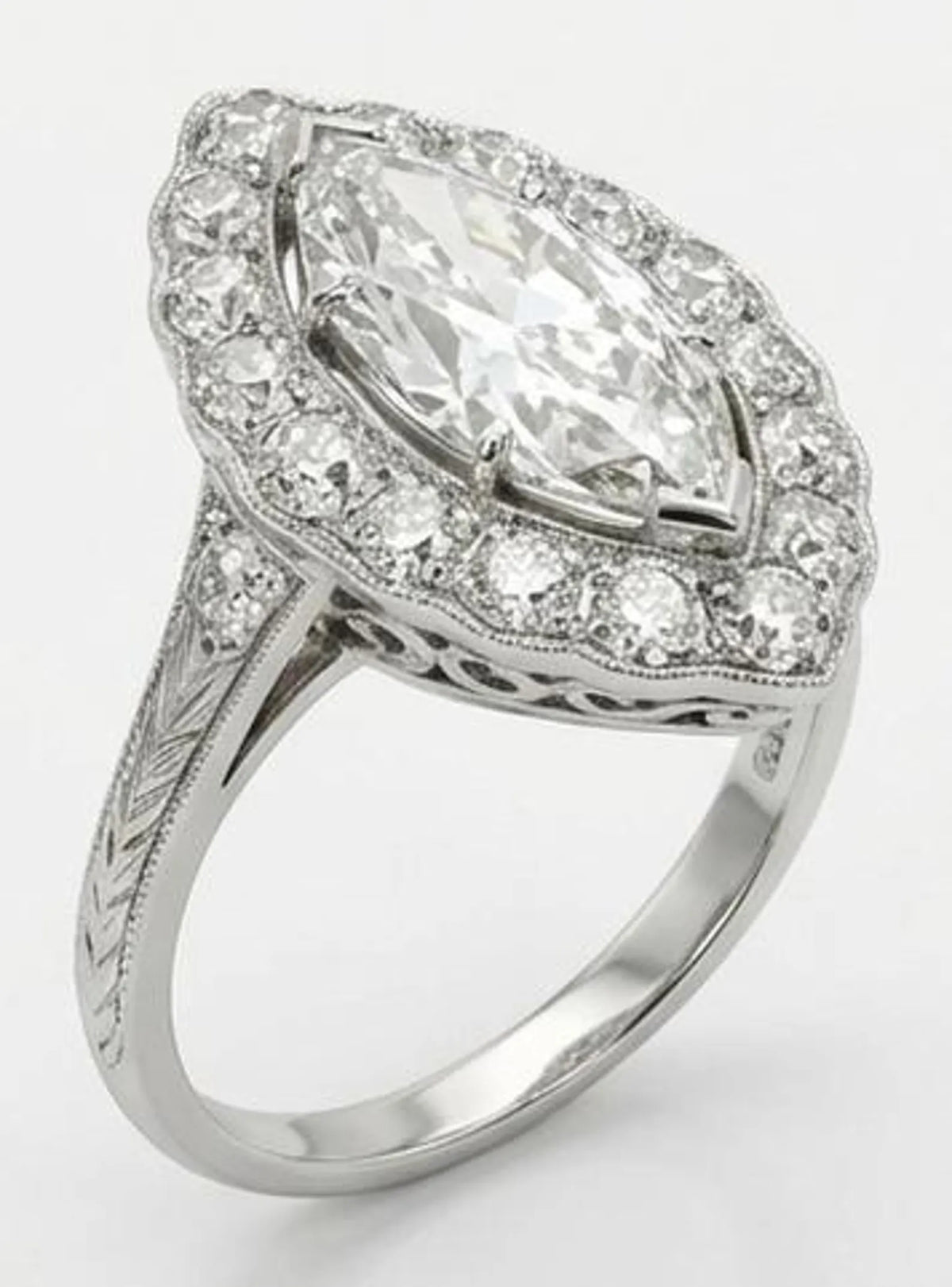 Three-quarter angle view of 3ct marquise lab diamond ring featuring engraved shoulders and scalloped halo