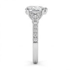 Close-up side profile of pavé diamond band and leaf motif basket setting on white gold heart ring