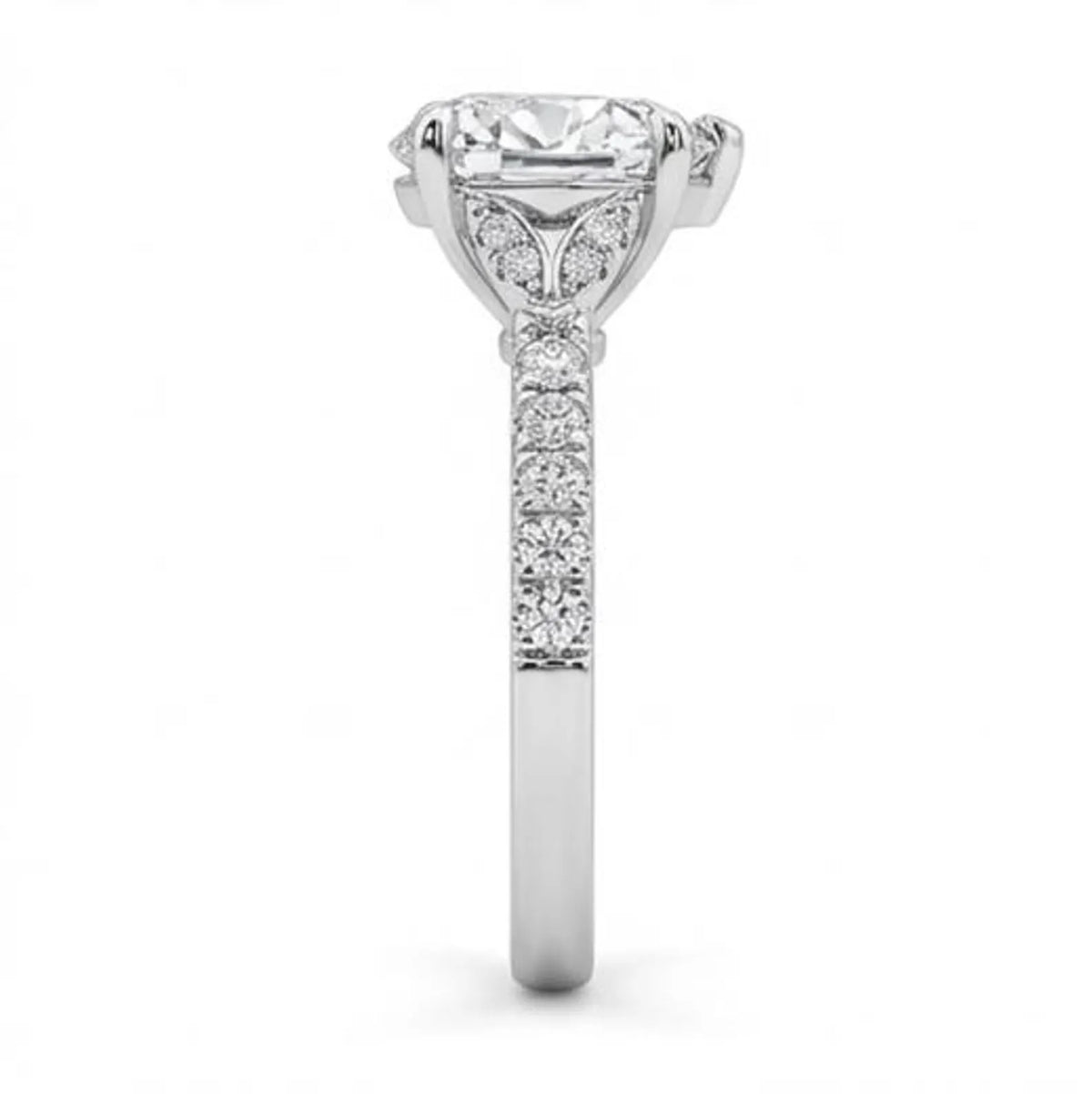 Close-up side profile of pavé diamond band and leaf motif basket setting on white gold heart ring