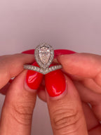 Close-up view of 2 carat pear cut lab grown diamond halo ring with V-shaped pavé band.