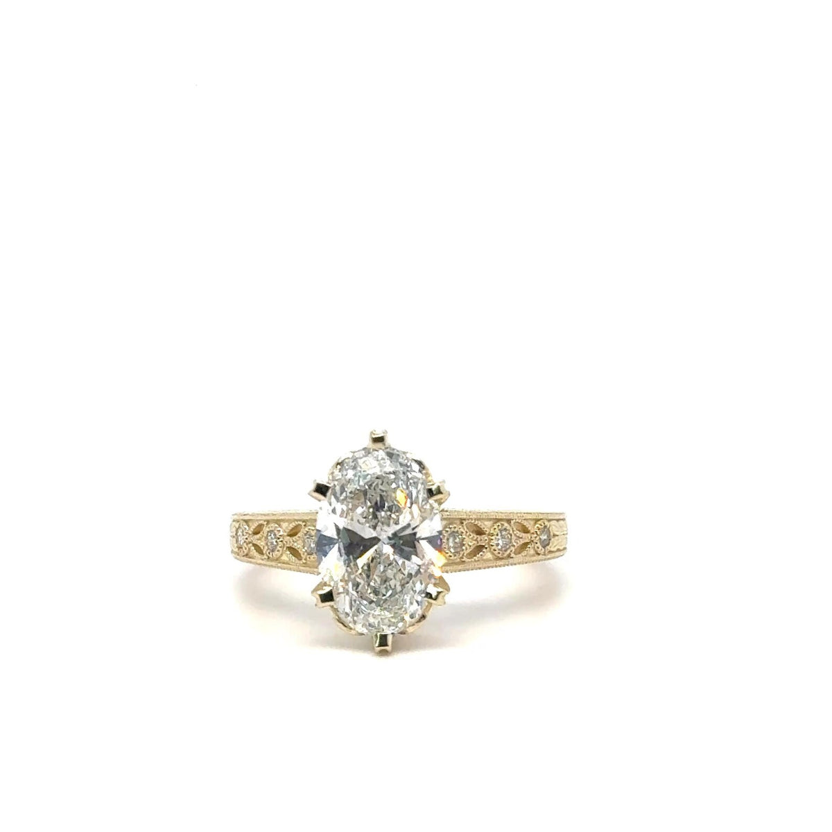 Top-down front view of 3 CT oval cut lab grown diamond in yellow gold vintage filigree setting
