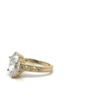 Close-up of intricate filigree work and accent diamond details on yellow gold ring band.