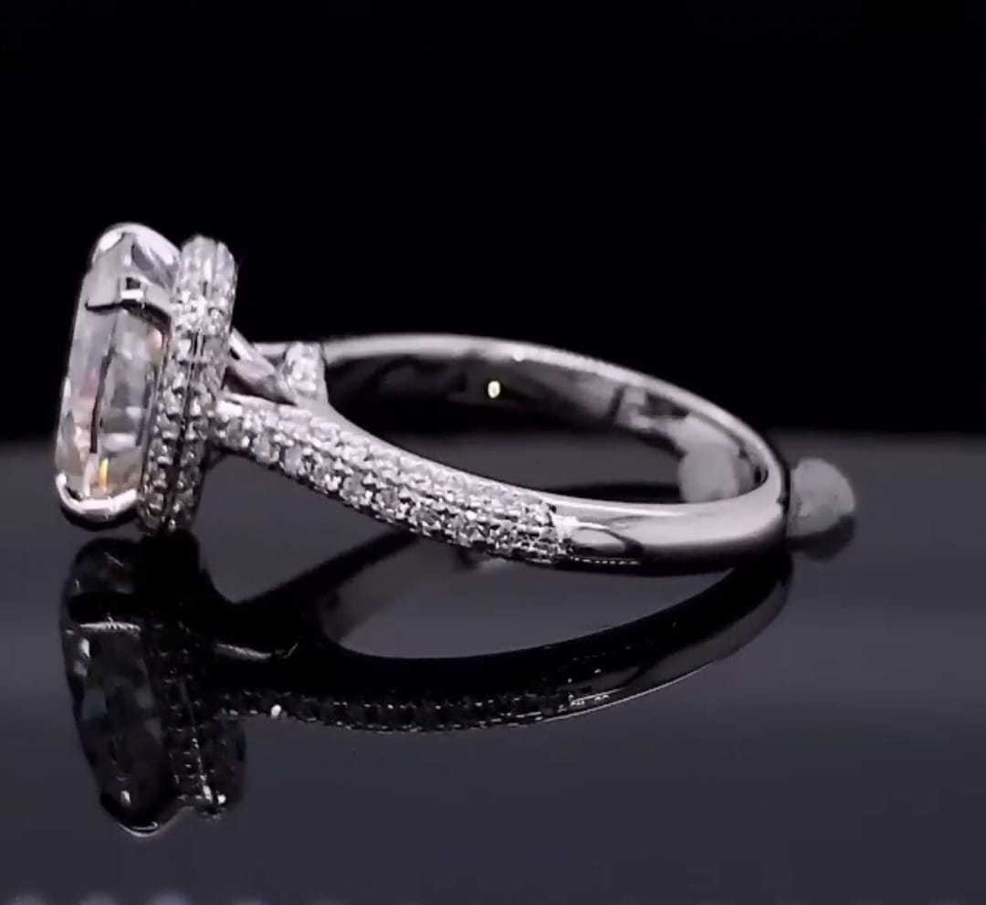 Side profile displaying bridge structure and hidden halo setting of a 3 CT cushion cut diamond ring.