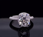 Close-up front view of a 3 carat elongated cushion cut lab grown diamond on a paved white gold band.