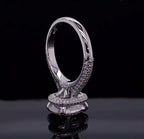 Vertical view showcasing under-halo and pavé band architecture of a cushion cut diamond ring.