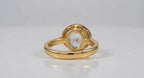 Underside and inner band view of 3 CT yellow gold oval bezel engagement ring.