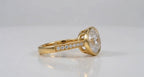 Side profile view of 3 carat horizontal oval cut lab grown diamond ring in gold bezel.
