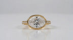 Straight-on front view of 3 CT horizontal oval lab diamond ring in protective bezel setting.