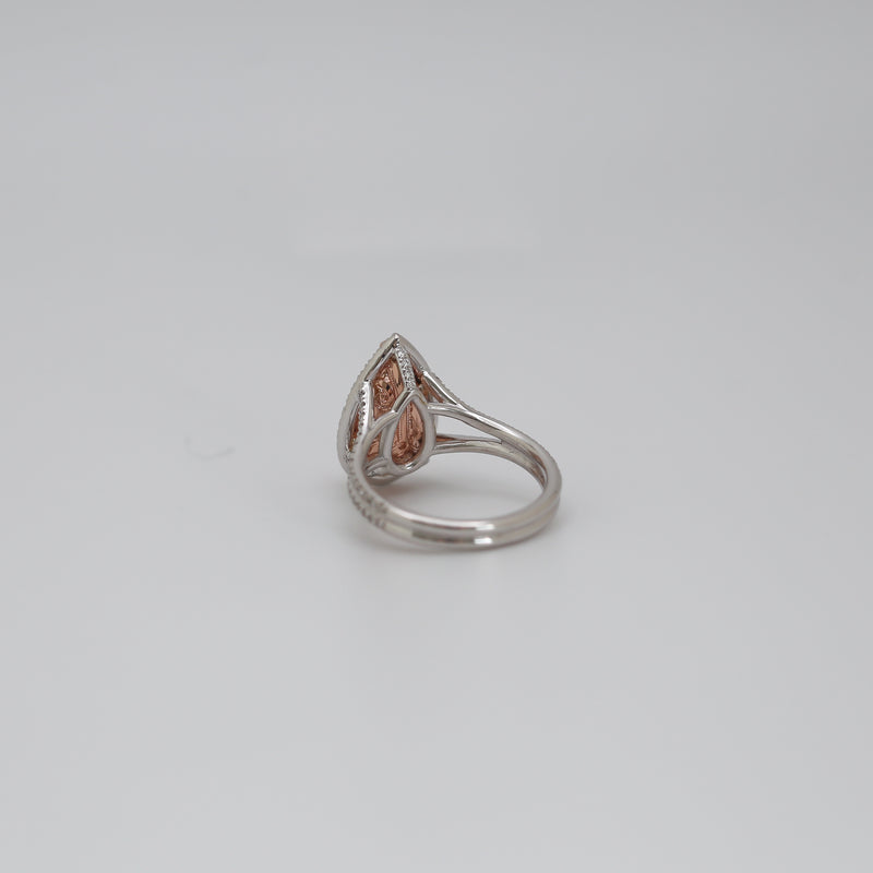 Side profile of 3 CT fancy pink pear cut lab grown diamond engagement ring showing rose gold basket and split shank pavé band.
