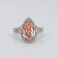 Front top-down view of 3 CT fancy pink pear cut lab grown diamond halo engagement ring in two-tone setting.