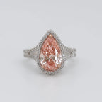 Front top-down view of 3 CT fancy pink pear cut lab grown diamond halo engagement ring in two-tone setting.