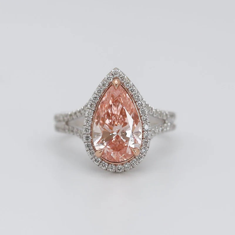 Front top-down view of 3 CT fancy pink pear cut lab grown diamond halo engagement ring in two-tone setting.