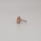 Angled view of 3 CT fancy pink pear cut lab diamond ring with micro-pavé halo and split shank band.