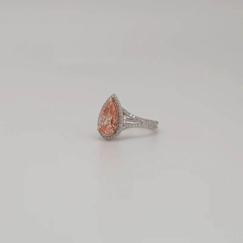 Angled view of 3 CT fancy pink pear cut lab diamond ring with micro-pavé halo and split shank band.