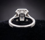 Underside view of 3 CT emerald cut lab grown diamond vintage ring highlighting open gallery and scroll filigree work.