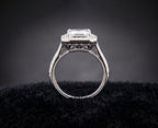 Side profile view of vintage Art Deco 3 CT emerald cut lab diamond engagement ring with milgrain band and filigree basket.