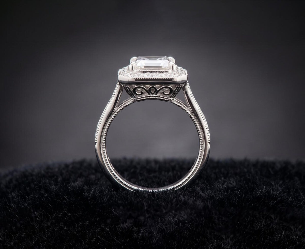 Side profile view of vintage Art Deco 3 CT emerald cut lab diamond engagement ring with milgrain band and filigree basket.