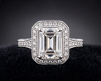 Top view of 3 CT emerald cut lab grown diamond ring with vintage milgrain halo setting in white gold.