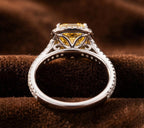 Side profile of fancy yellow radiant cut diamond halo ring with intricate scroll gallery details