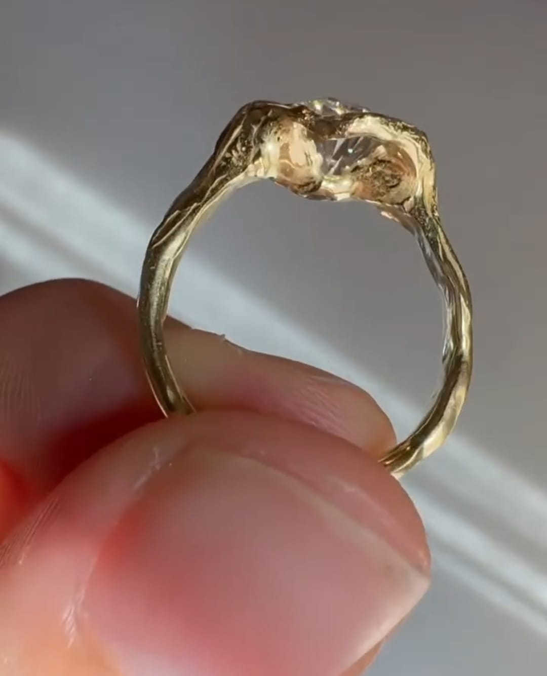 Side profile of 4 carat oval lab grown diamond ring with organic textured gold setting