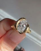Close-up view of 4ct oval cut lab grown diamond set in molten yellow gold