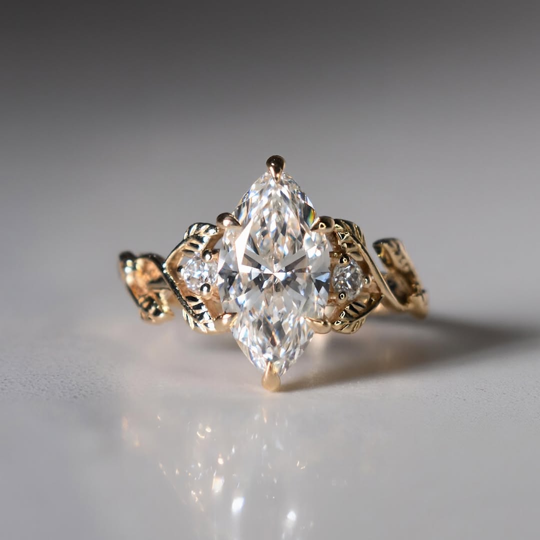 Front view of 3 carat marquise cut lab grown diamond engagement ring with yellow gold leaf band