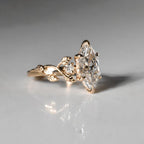 Detailed side view of 3ct marquise diamond ring with sculpted leaf motif and prong setting
