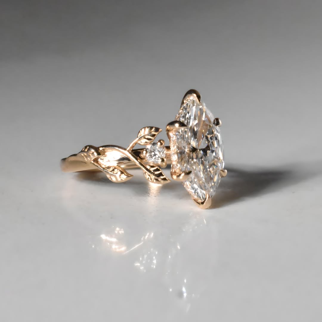 Detailed side view of 3ct marquise diamond ring with sculpted leaf motif and prong setting