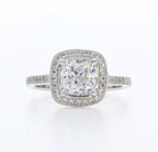 Top view of 3 CT cushion cut lab grown diamond engagement ring with vintage milgrain halo and pave diamond band.