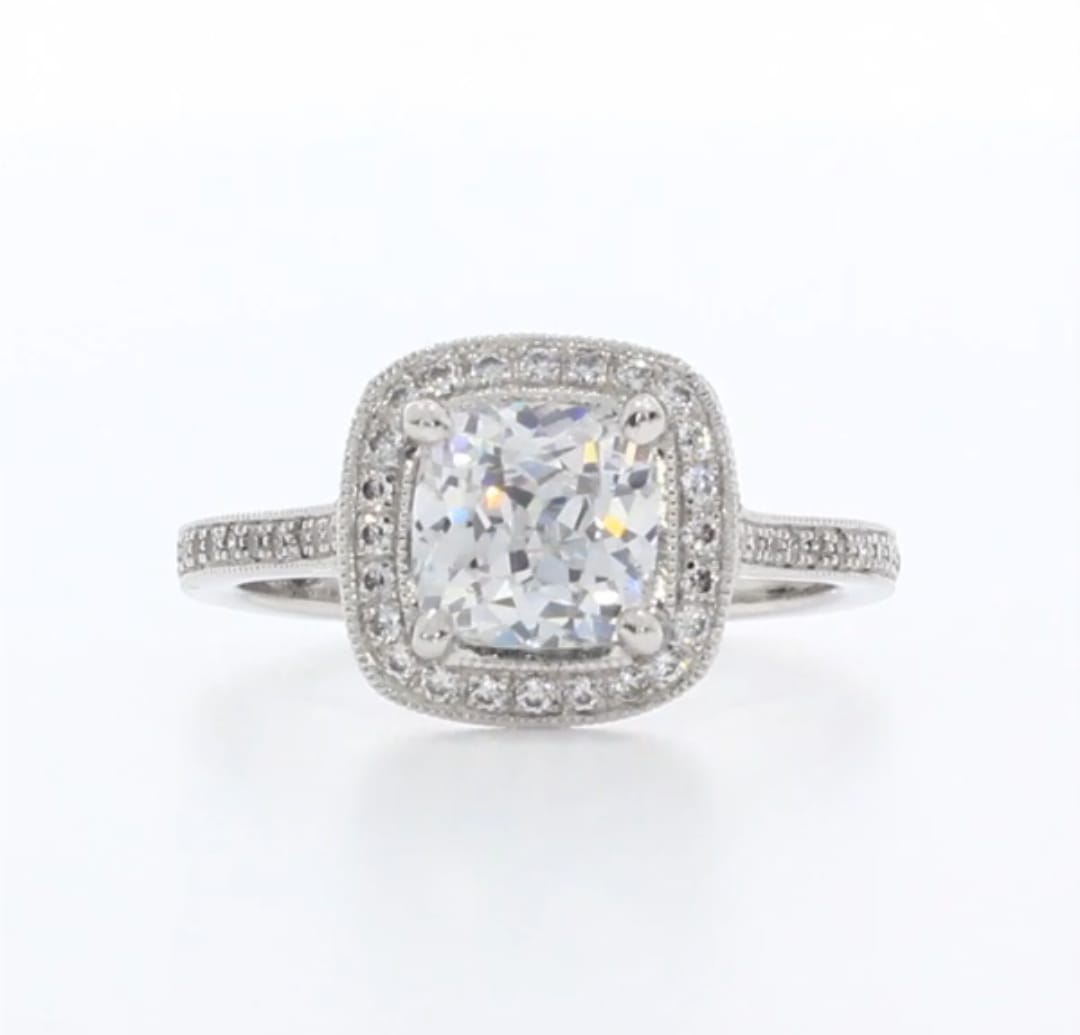 Top view of 3 CT cushion cut lab grown diamond engagement ring with vintage milgrain halo and pave diamond band.