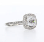 Three-quarter angle perspective of 3 carat cushion cut lab created diamond ring showcasing halo brilliance and milgrain detail.