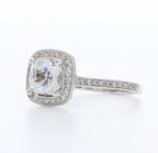 Close-up side angle of 3 CT cushion cut lab diamond ring highlighting pave band and detailed milgrain edging.