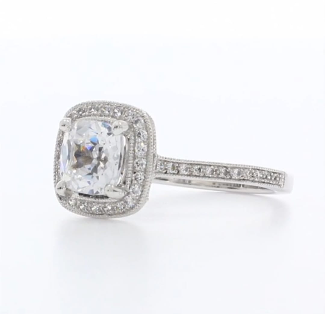 Close-up side angle of 3 CT cushion cut lab diamond ring highlighting pave band and detailed milgrain edging.