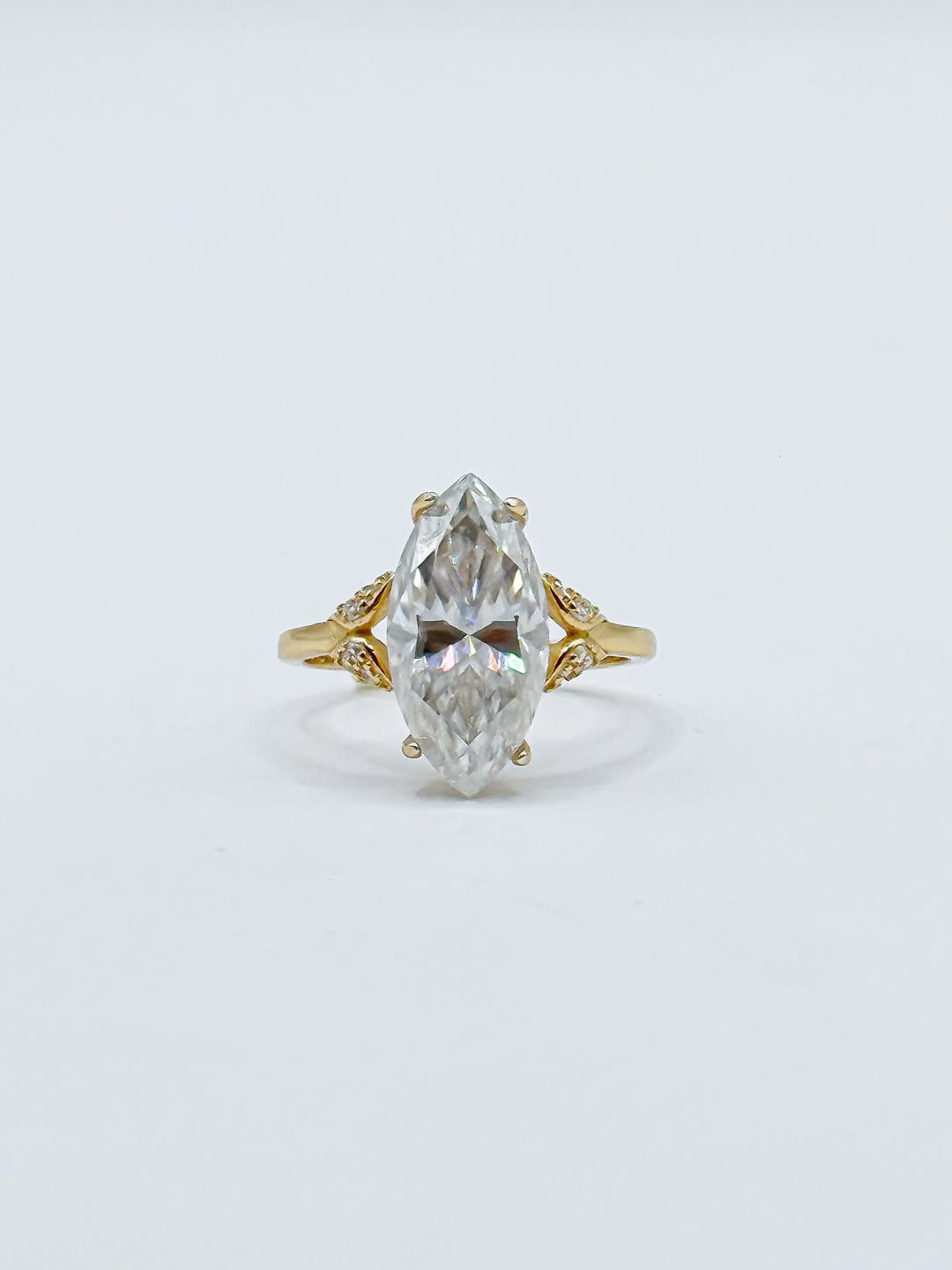 Front studio view of a 3 CT marquise cut lab grown diamond ring with gold leaf-inspired accent shoulders.