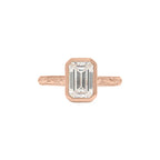 Top view of rose gold 3 CT emerald cut lab diamond ring with protective bezel setting and engraved detailing.