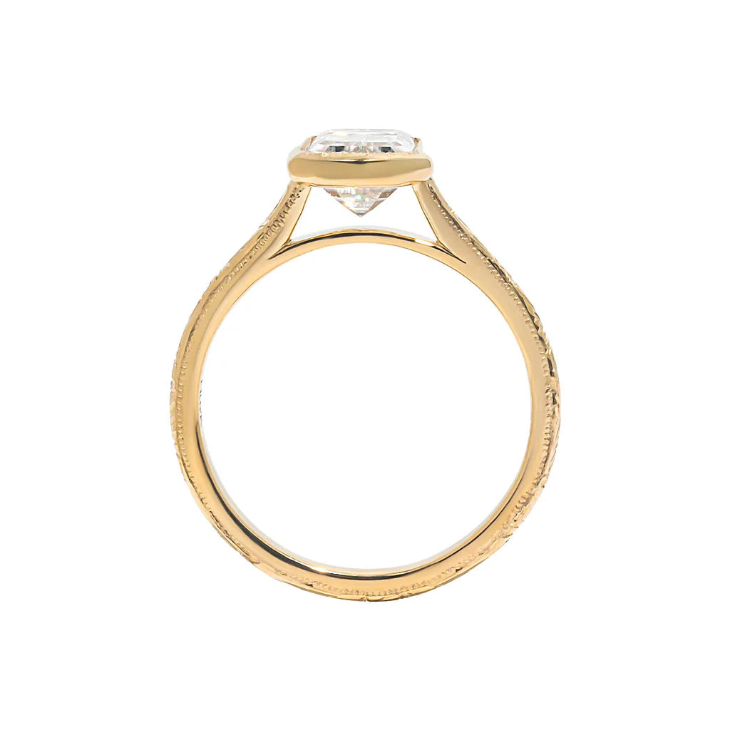 Side profile view of 3 CT emerald cut lab diamond ring showing bezel basket height and milgrain edge band details.