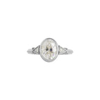 Top view of white gold 2 CT oval cut lab grown diamond ring with protective milgrain bezel setting.