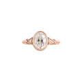 Top view of rose gold 2 CT oval cut lab diamond ring with triangular milgrain side accents.