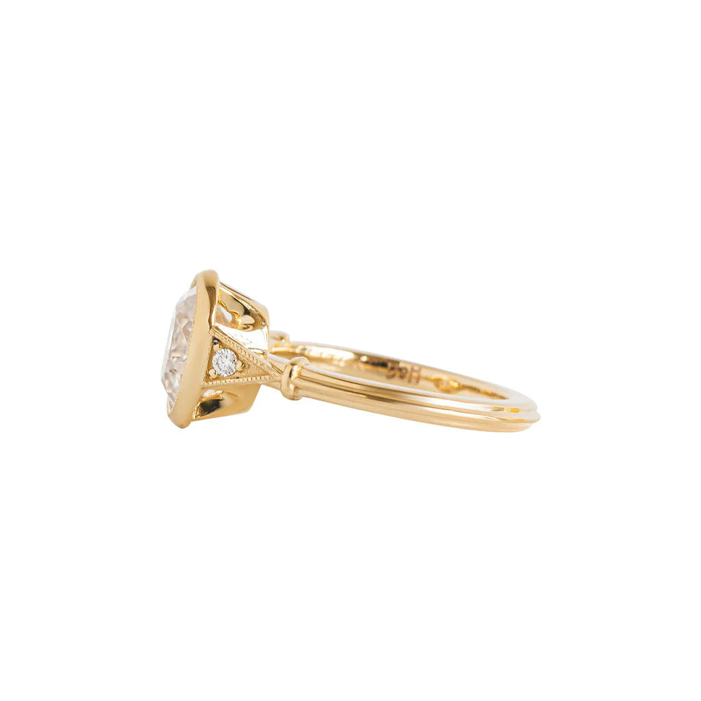 Three-quarter side angle of yellow gold 2 CT oval lab diamond engagement ring highlighting shoulder detail.