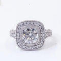 Top-down view of a 2 CT cushion cut lab grown diamond engagement ring featuring a double halo and milgrain edging.