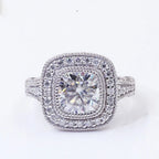 Top-down view of a 2 CT cushion cut lab grown diamond engagement ring featuring a double halo and milgrain edging.