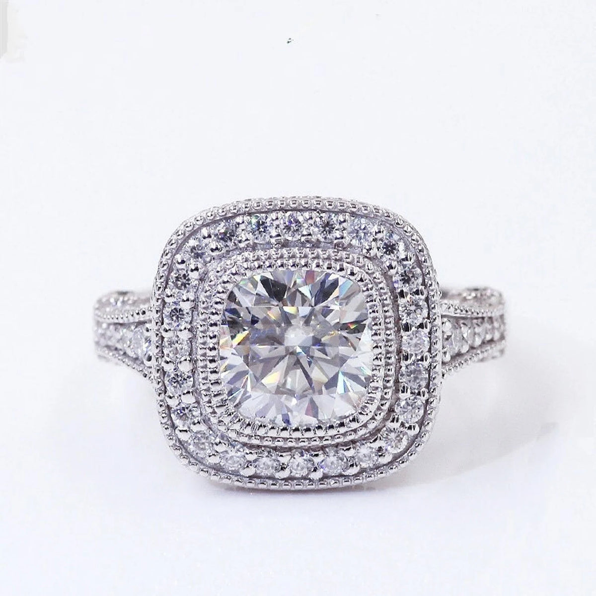 Top-down view of a 2 CT cushion cut lab grown diamond engagement ring featuring a double halo and milgrain edging.