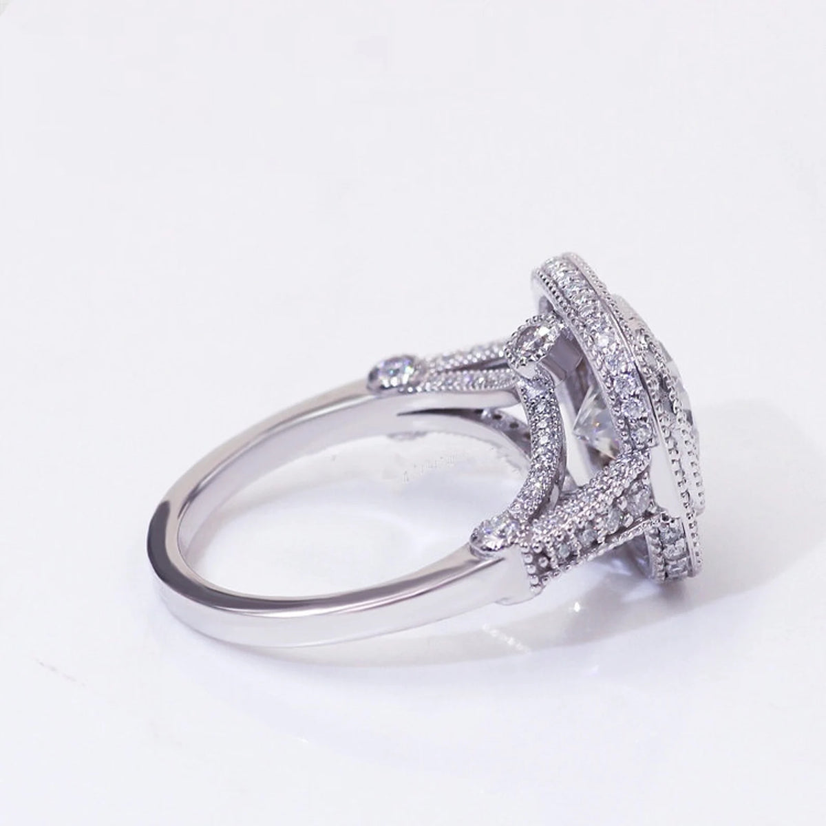 Side profile view of cushion cut lab diamond ring displaying cathedral setting, micro-pavé bridge, and milgrain details.