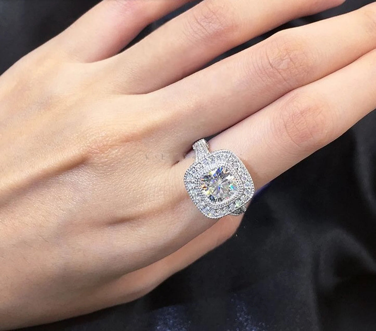 Top-down view on hand displaying full finger coverage and brilliance of 2 CT cushion cut double halo lab diamond ring.