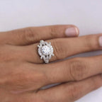 Top-down view on hand displaying finger coverage of a 2 CT round lab diamond vintage filigree engagement ring.