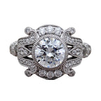 Isolated top-down view of round cut lab diamond engagement ring with vintage filigree shoulders.